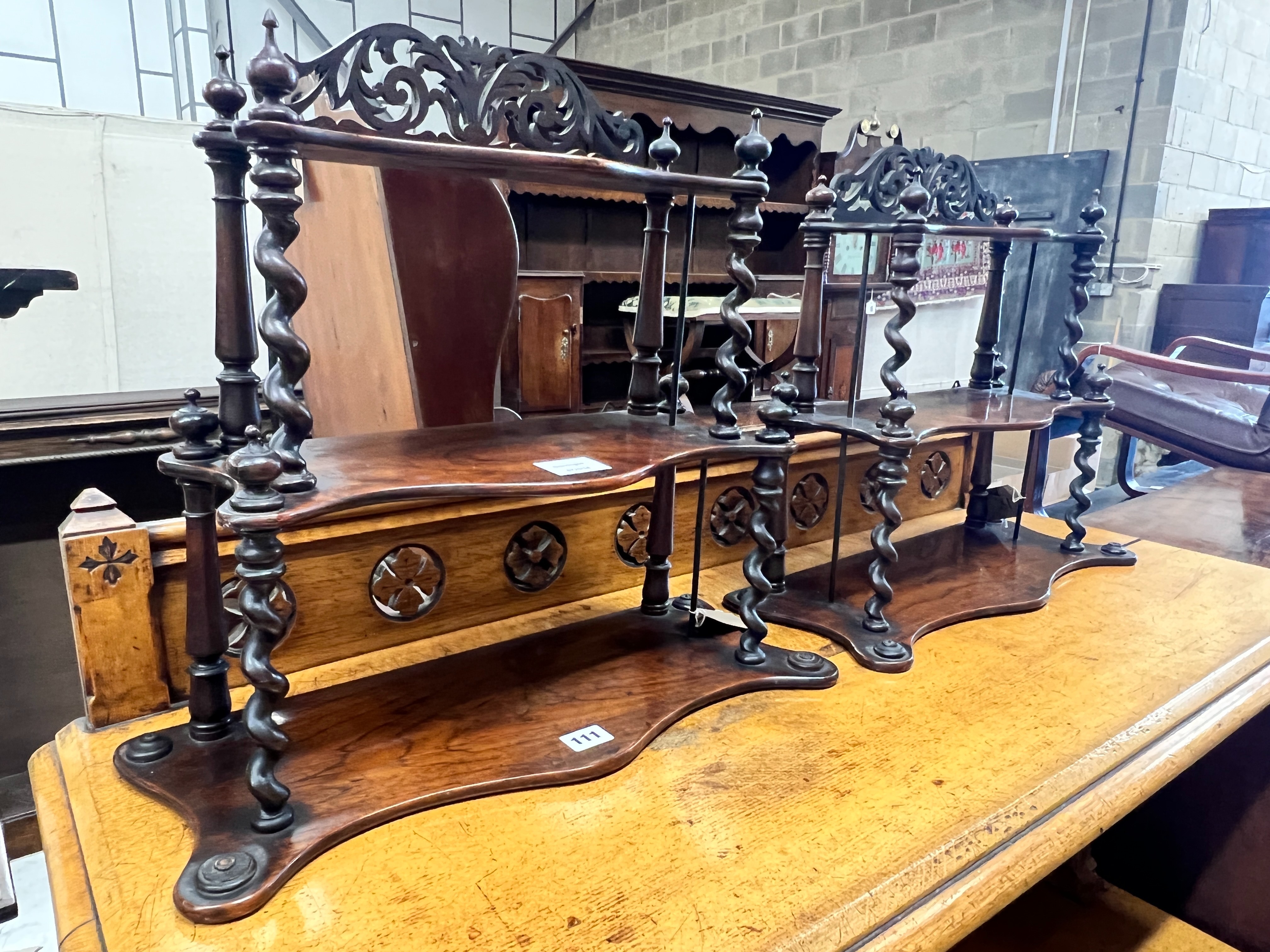 A pair of Victorian rosewood serpentine three tier wall brackets, (altered), width 50cm, depth 20cm, height 46cm